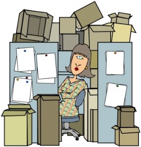 woman at cluttered cubicle