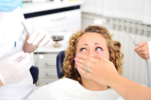 Scared girl at Dentist's teeth checkup